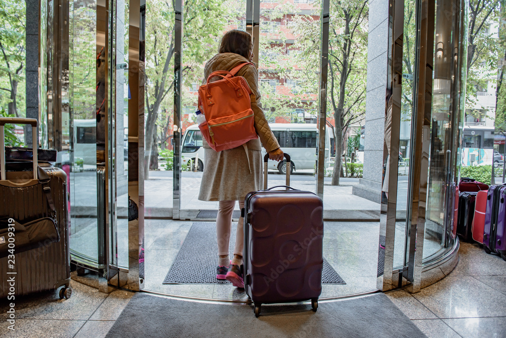 Woman carrying suitcase bag from hotel for travelling. Woman carrying suitcase bag from hotel for travelling.