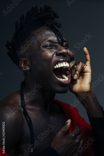 Portrait of a male African American screaming with a finger in his mouth