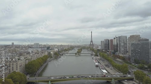 Flying in Paris, France, over Seine River, Statue of Liberty and les arrondments