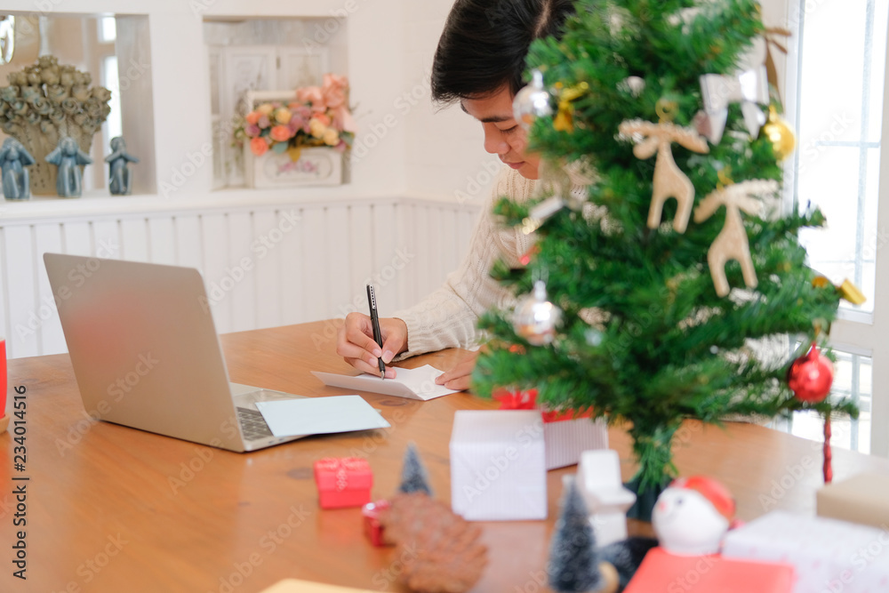 man writing christmas letter greeting card holiday wishes with xmas decoration man writing christmas letter greeting card holiday wishes with xmas decoration
