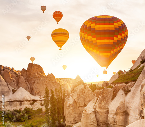 Hot air balloon flying over rock landscape at Cappadocia Turkey