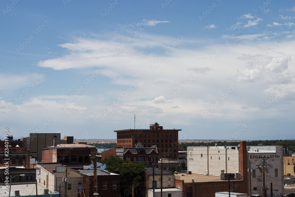 Cityscape summer day. Roof buildings of a small American city against the backdrop of mountains.