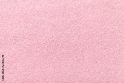 Light pink matt suede fabric closeup. Velvet texture of felt.