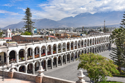 Arequipa, Peru - October 7, 2018: Colonial buildings and archways made of white Sillar stone in the Plaza de Armas, Arequipa