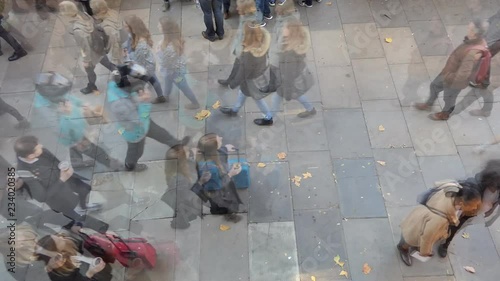 Time lapse. A high angle view of a busy street with crowd passing by.