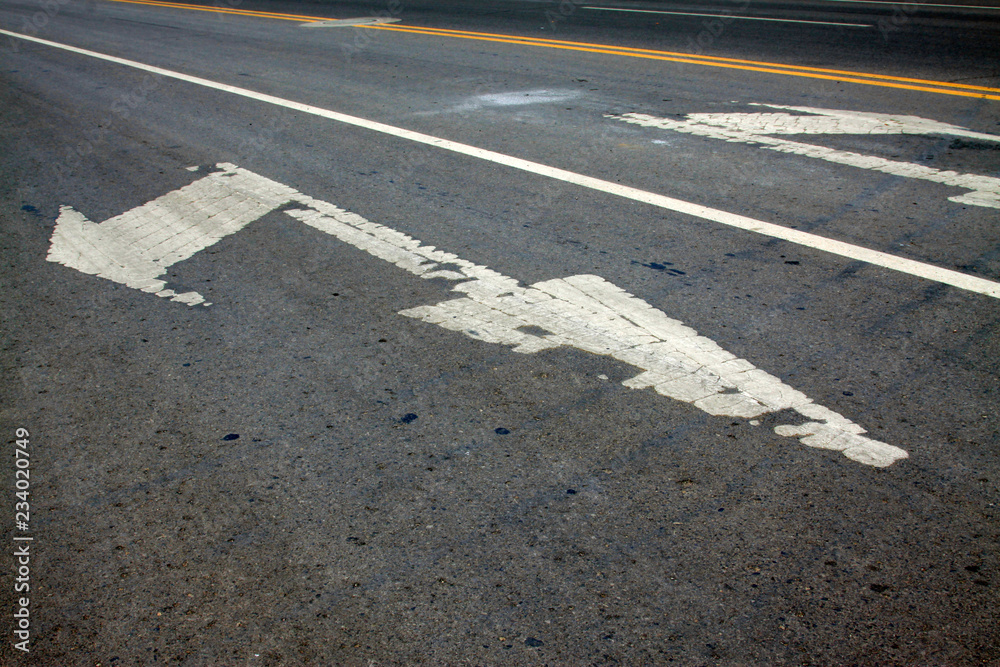 arrow mark on asphalt pavement, closeup photo arrow mark on asphalt pavement, closeup photo