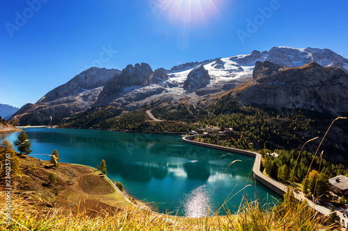 Fototapeta Naklejka Na Ścianę i Meble -  Lago Fedaia (Fedaia Lake), Fassa Valley, Trentino Alto Adige, an artificial lake and a dam near Canazei city, located at the foot of Marmolada massif.