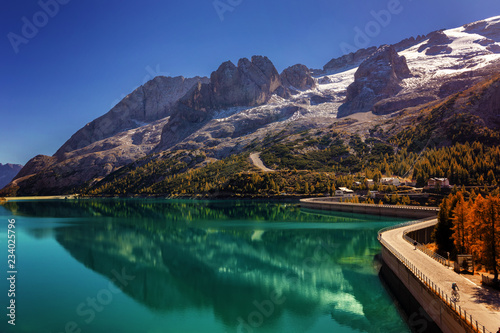 Fototapeta Naklejka Na Ścianę i Meble -  Lago Fedaia (Fedaia lake), an artificial lake and a dam near Canazei city, located at the foot of Marmolada massif, as seen from Viel del Pan refuge, Dolomites, Trentino, province of Belluno, Italy