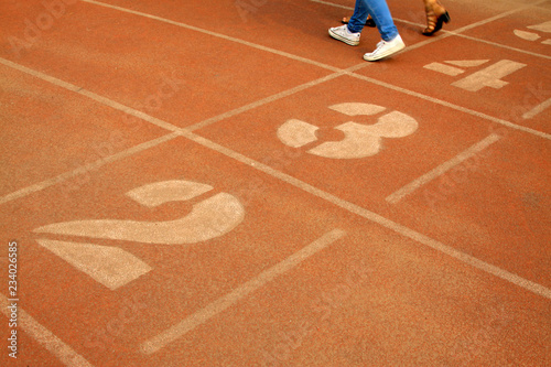 green number on plastic runway in a sports ground