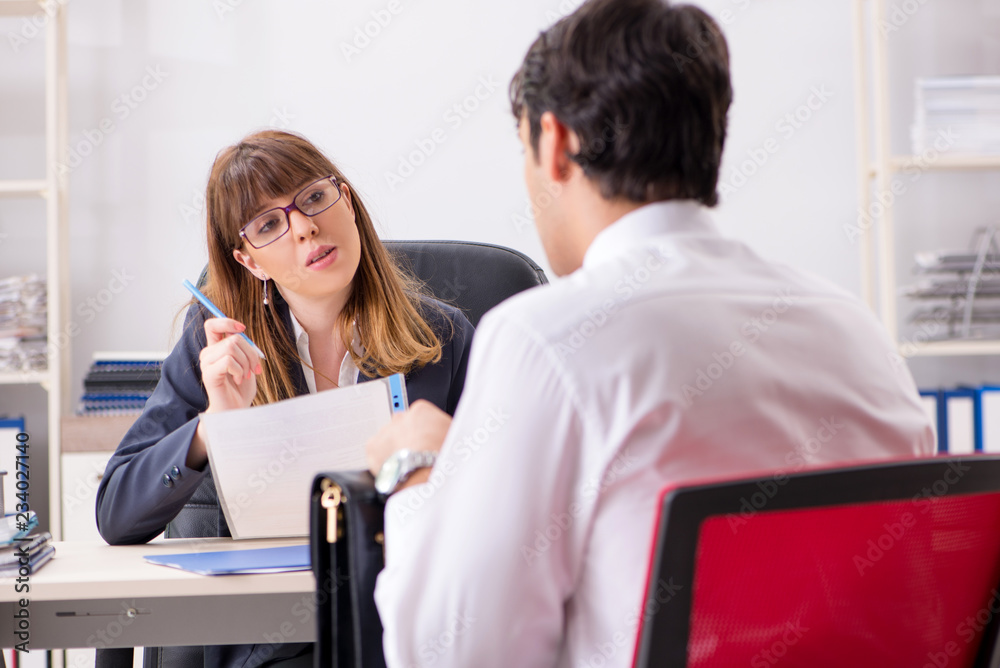 Man and woman discussing in office Man and woman discussing in office