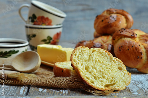 Freshly baked Kaiser rolls with poppy seeds on a wooden background