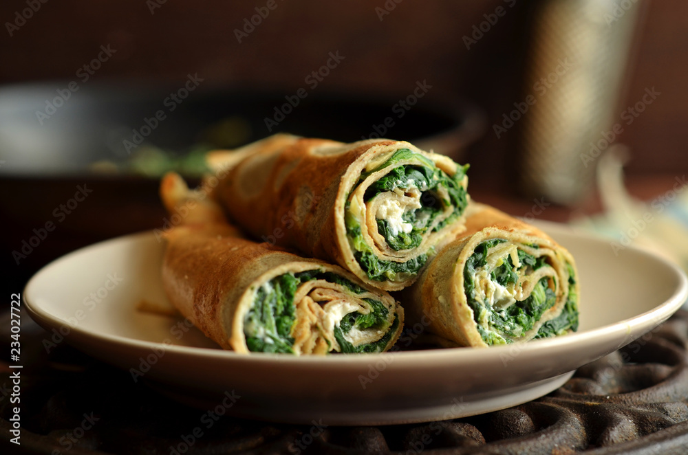 Fotografie Pancakes with spinach on a white plate
