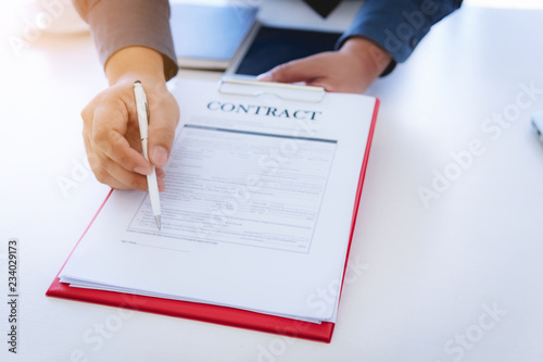 Close up hand of business man signing contract documents on office. Law and Legal concept.