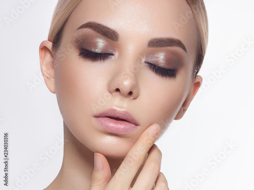 Lips Skin Care. Beautiful Woman With Beauty Face Applying Lip Balsam, Lipbalm On Full Sexy Lips. Portrait Of Smiling Female Model With Soft Skin And Natural Nude Makeup Touching Lips. High Resolution photo