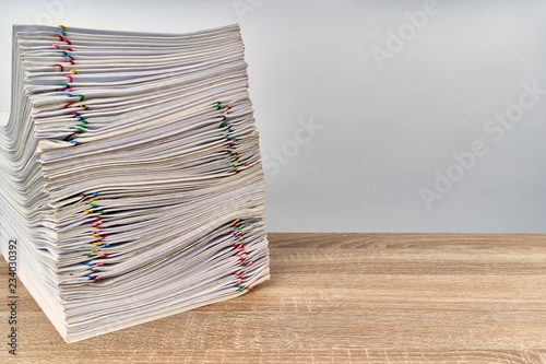 Stack overload paperwork report on wooden table with copy space