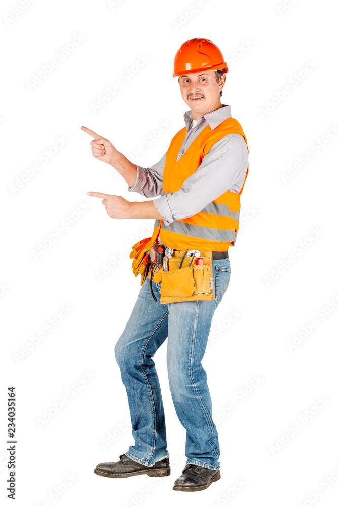 Portrait of a male builder in a helmet looking at camera over white wall background. repair, construction, building, people and maintenance concept. Portrait of a male builder in a helmet looking at camera over white wall background. repair, construction, building, people and maintenance concept.