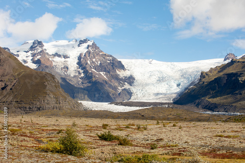 Mountain landscape with glacier and stones. Bold background