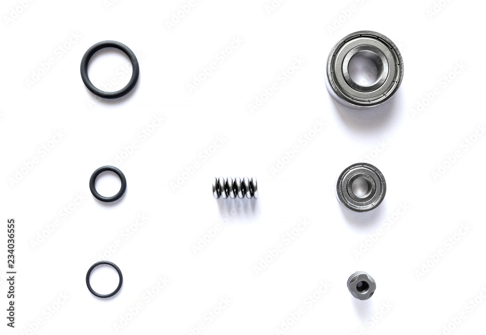 Top view of spare parts is bearing with tire ring and spring are small placed on white floor. - obrazy, fototapety, plakaty 