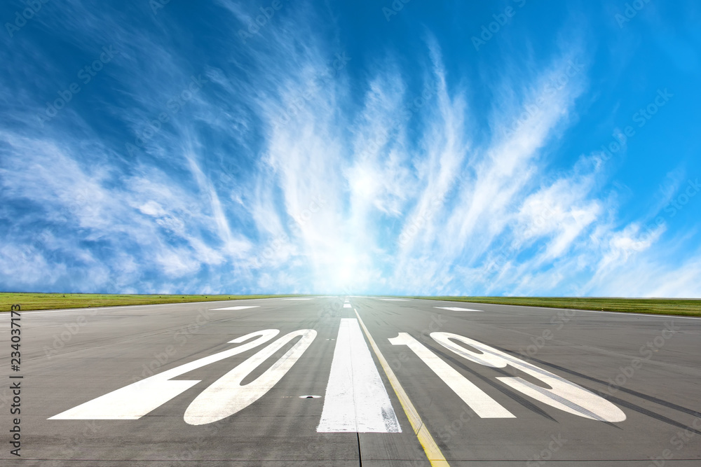 Fototapeta premium Runway asphalt road with the inscription 2019 year with a beautiful sky. The concept of the beginning of new goals and affairs.