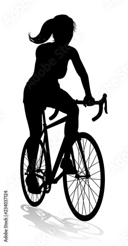 Fototapeta Naklejka Na Ścianę i Meble -  A woman bicycle riding bike cyclist in silhouette