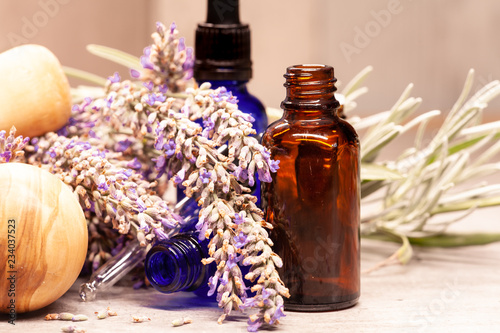 Fototapeta Naklejka Na Ścianę i Meble -  lavender mortar and pestle and bottles of essential oils for aromatherapy