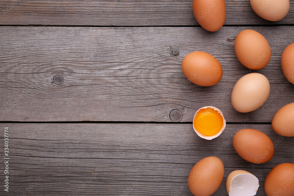 Chicken eggs and half with yolk on a grey background. Chicken eggs and half with yolk on a grey background.