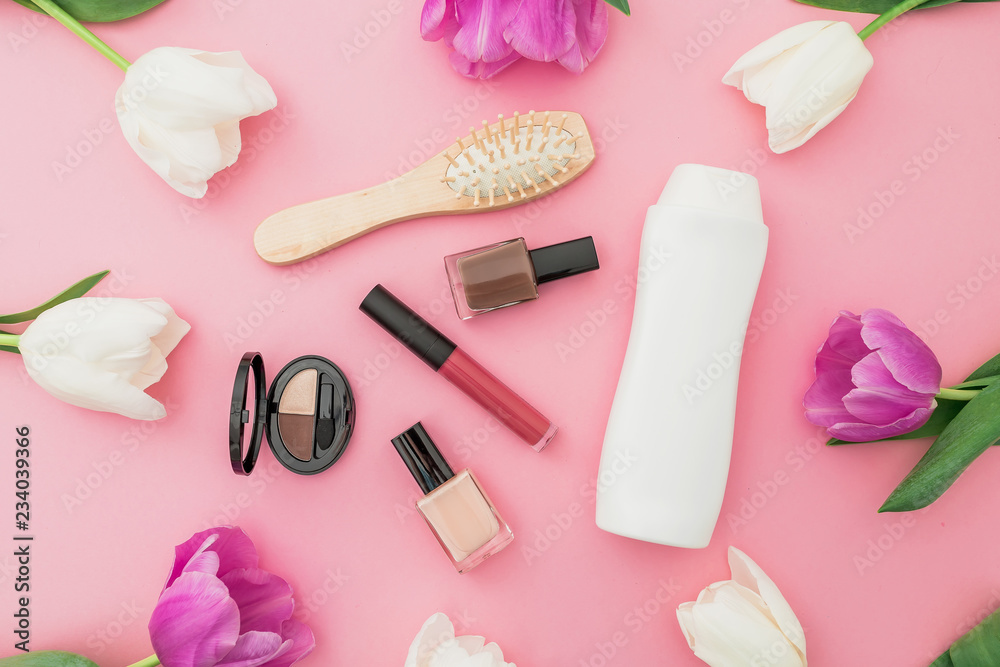 Composition with flowers and cosmetics on pink background. Top view. Flat lay. Feminine desk. Composition with flowers and cosmetics on pink background. Top view. Flat lay. Feminine desk.