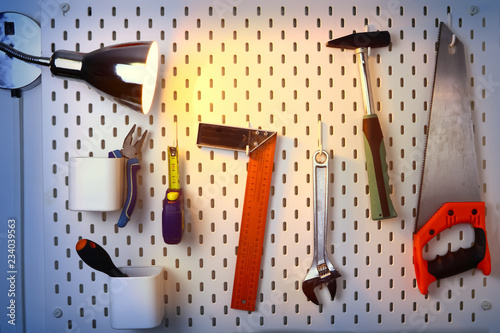 various construction tools hanging on the wall and a glow lamp