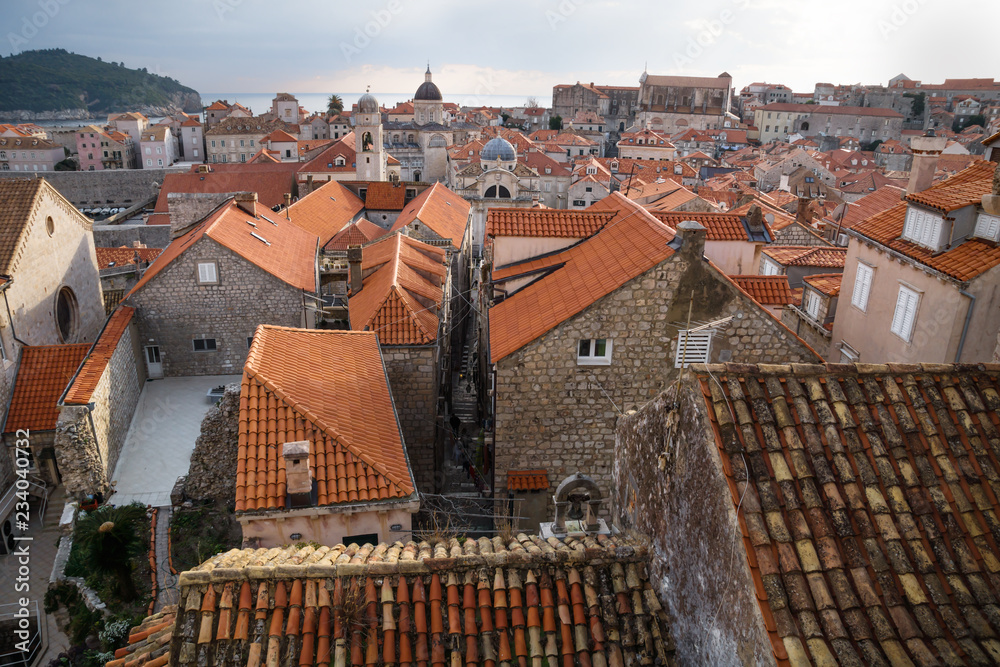 View over the ancient roofs of old town Dubrovnik with church towers and ocean in winter, Croatia