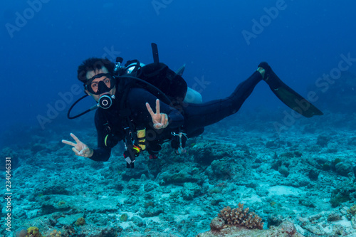 SCUBA diver underwater on a tropical coral reef