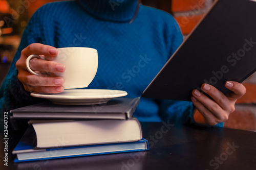 A girl with coffee and books