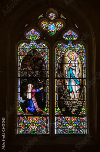 Colorful Stained Glass in medieval Sarlat Cathedral dedicated to Saint Sacerdos. Sarlat la Caneda in Dordogne Department, Aquitaine, France