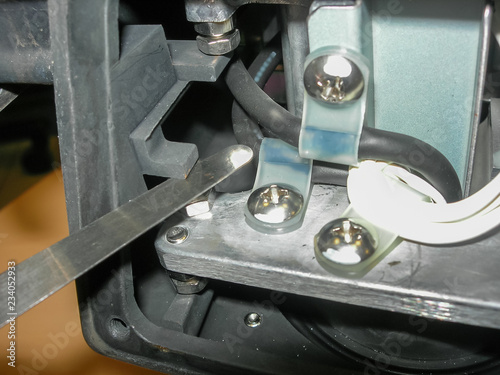 Engineer is measuring of the dimension of small gaps using metal feeler gauge in weighing equipment. Repair of weighing equipment. Industry concept. Tool for checking the clearance between parts.