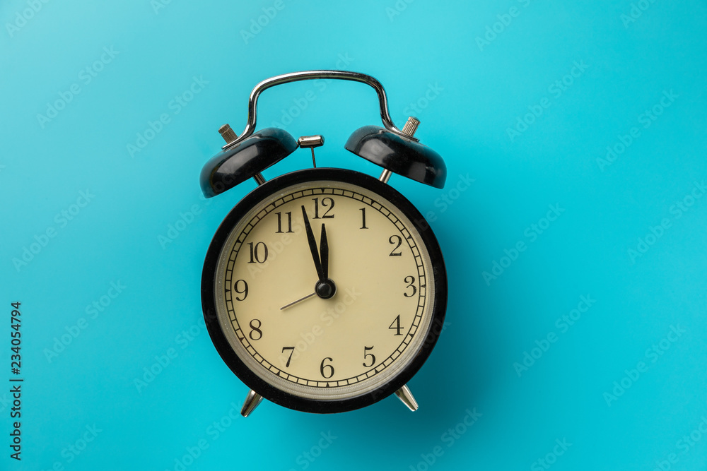black clock on a blue background. black clock on a blue background.