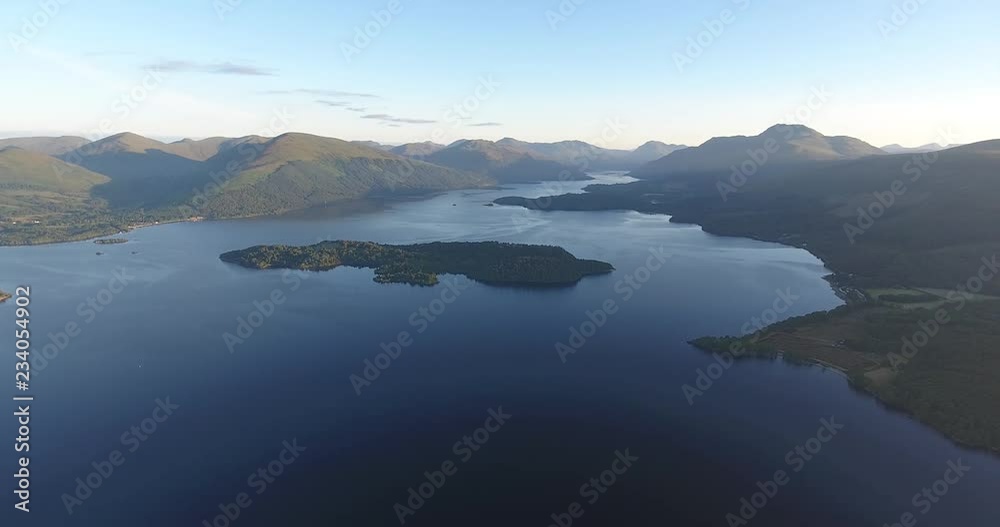 Inspiring and mystic aerial view from a drone of Loch Lomond in Scotland - Summer time with blue sky Inspiring and mystic aerial view from a drone of Loch Lomond in Scotland - Summer time with blue sky