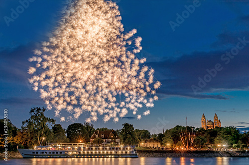 Fireworks over the Rhine with a ship and the cathedral in Speyer in Germany photo