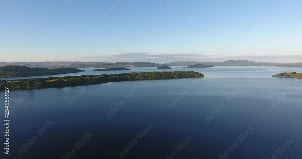 Inspiring and mystic aerial view from a drone of Loch Lomond in Scotland - Summer time with blue sky Inspiring and mystic aerial view from a drone of Loch Lomond in Scotland - Summer time with blue sky