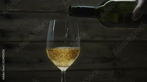 White wine pouring into a wine glass. Seamless cinemagraph video