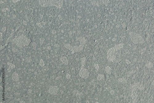 White crystalls of the sea salt on the grey metal deck of a ship. photo