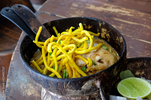 Thai food, curry noodle in coconut shell bowl 