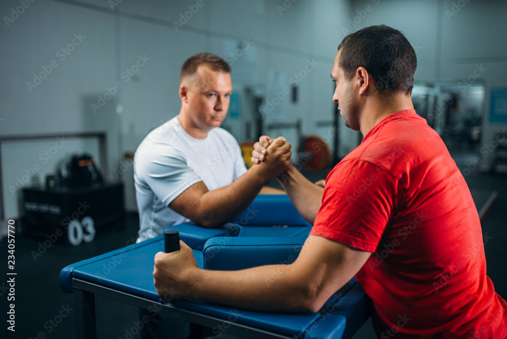 Two arm wrestlers at the table with pins, training Two arm wrestlers at the table with pins, training