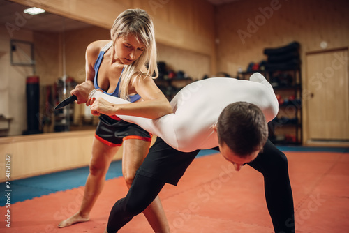 Woman makes elbow kick, self-defense workout