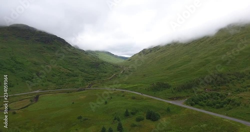 Small Road and River Drone Shot Between Hills in Scotland - Near Glencoe in the Highlands