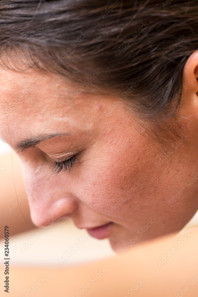 Close-up side view of a young woman on a seated / forward bend or Sleeping Swan asana or yoga pose. Close-up side view of a young woman on a seated / forward bend or Sleeping Swan asana or yoga pose.