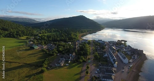 Scottish Hill Aerial Drone Pulling Back over Morning Countryside and Village - Inveraray Castle