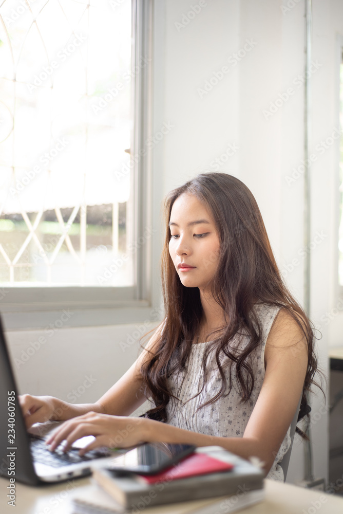 Asian female students are searching for information from a computer, studying life on campus. Asian female students are searching for information from a computer, studying life on campus.