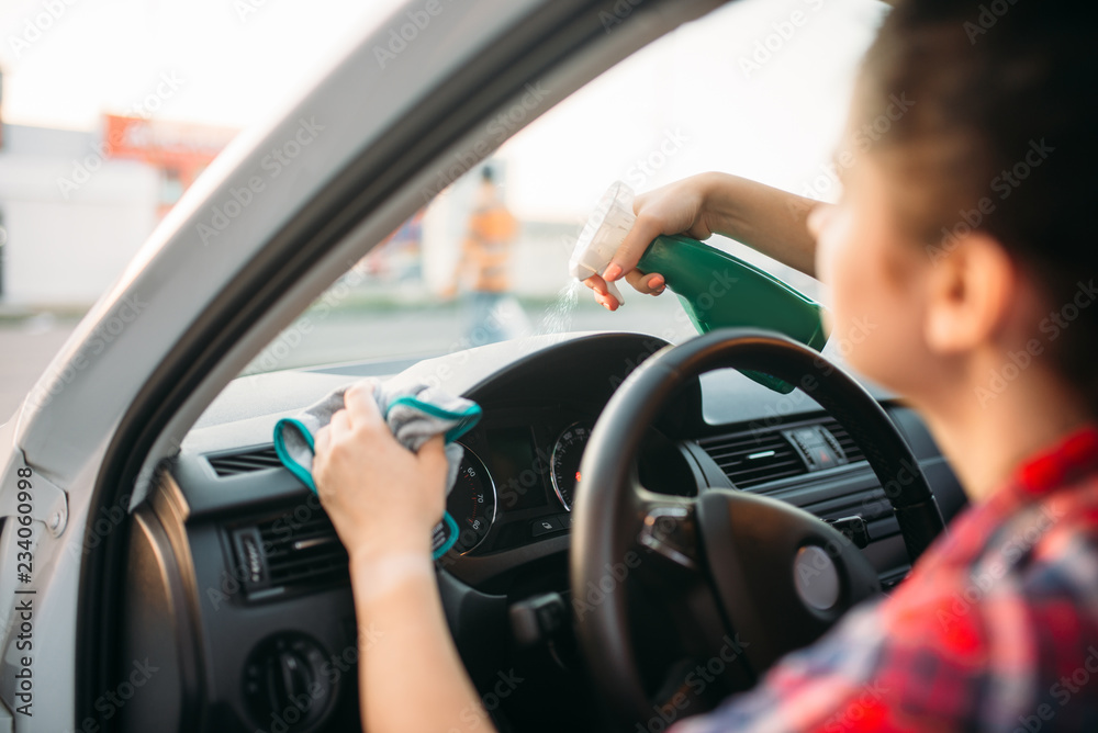 Female person polishes the dashboard of the car Female person polishes the dashboard of the car