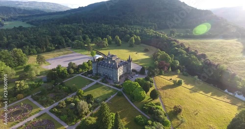 Scottish Hill Aerial Drone Pulling Back over Morning Countryside and Village - Inveraray Castle photo
