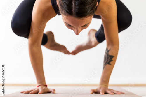 woman doing balance arm-pressing asana exercise