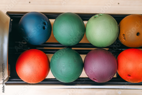 Rows of color bowling balls in feeder  top view